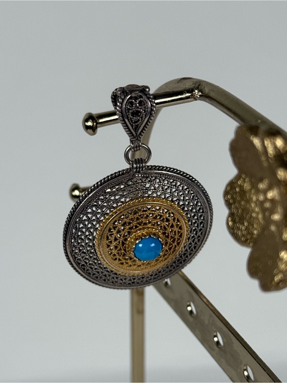 Sterling silver and plated gold filigree pendant with turquoise accent